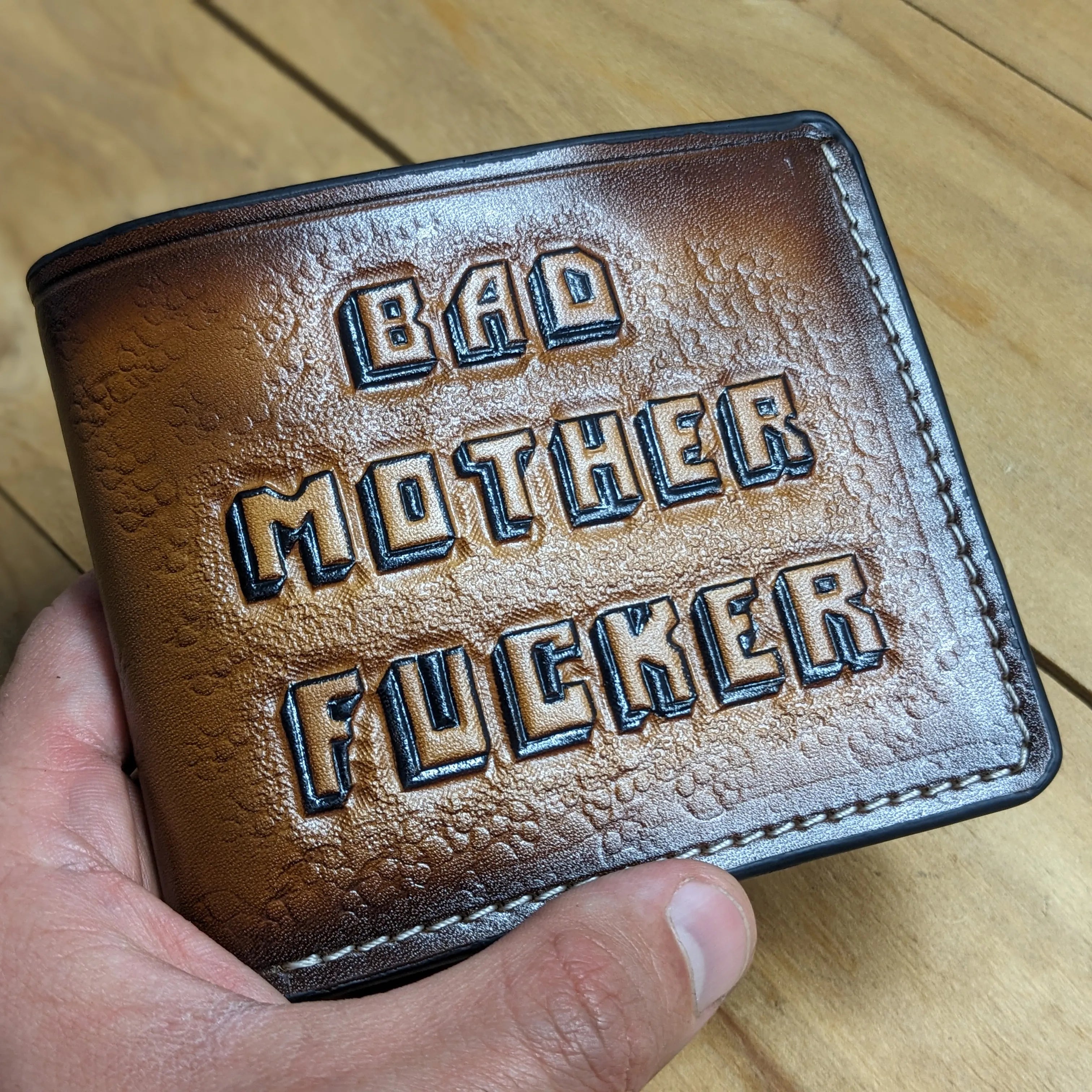 Close-up of “Bad Mother F*cker” hand-tooled leather wallet artwork