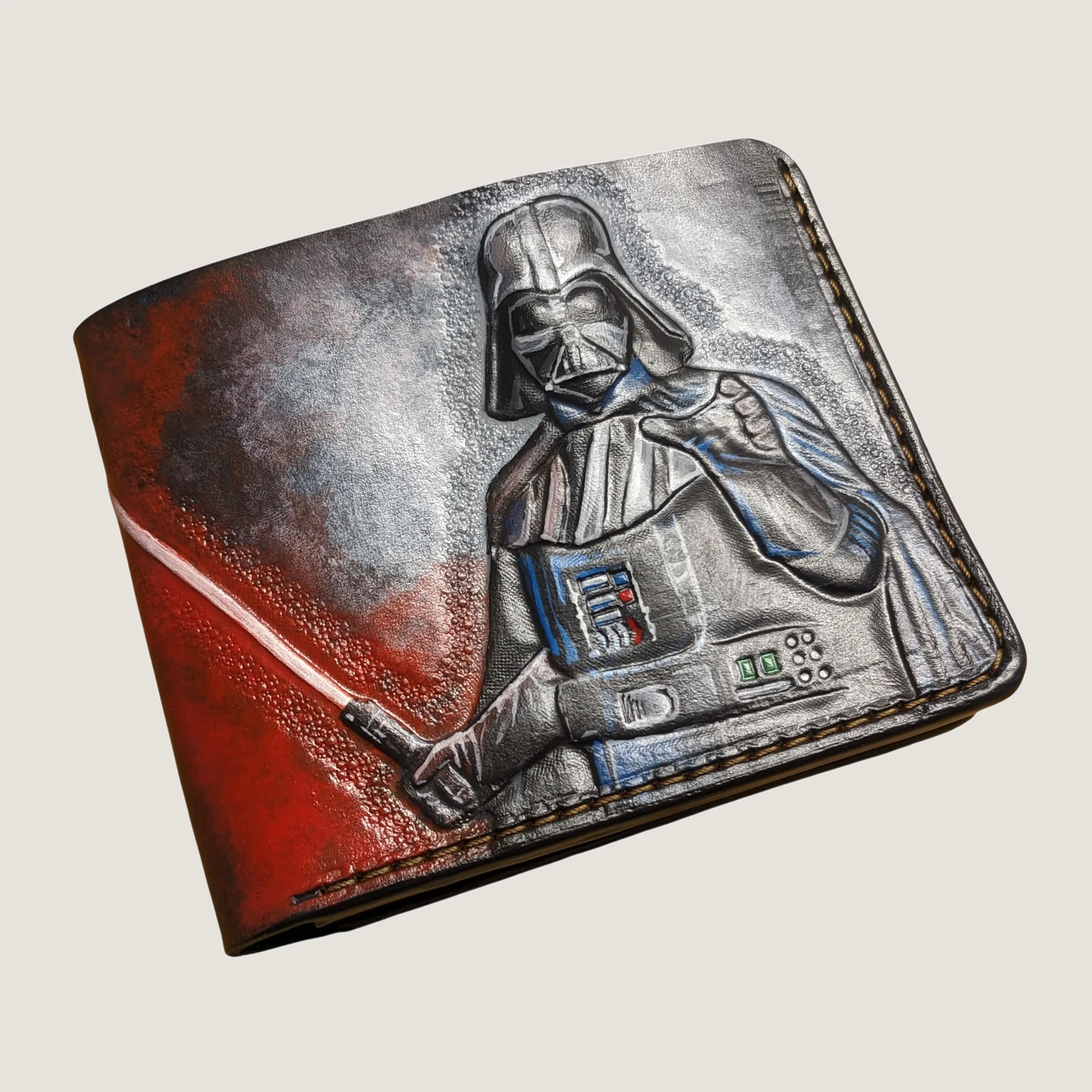 Hand-tooled Star Wars leather bifold wallet featuring a detailed Darth Vader helmet carving on a clean studio background.