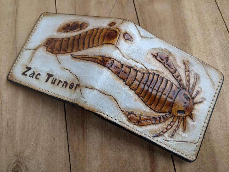 Close-up of eurypterid sea scorpion fossil embossed leather wallet