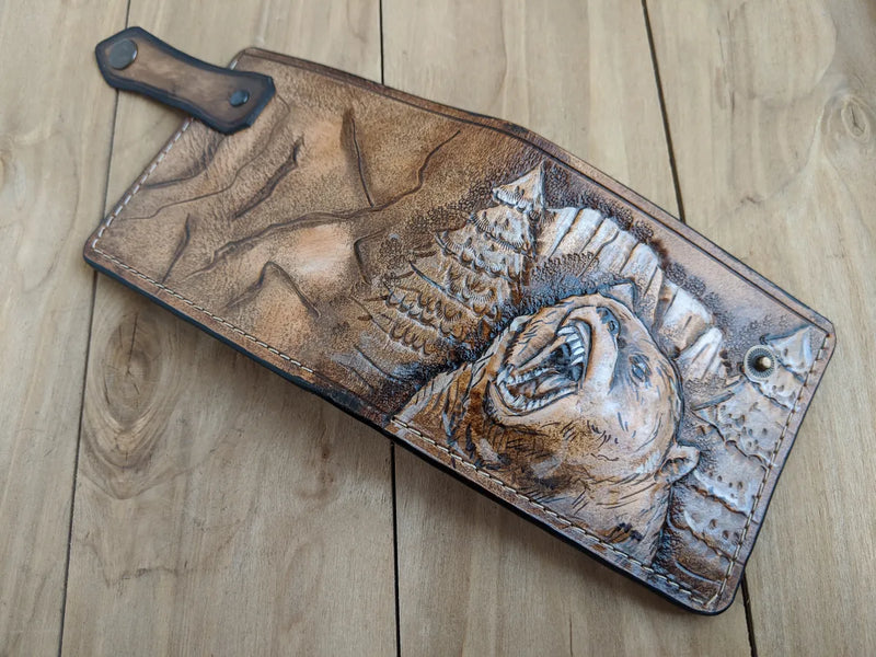 Carved grizzly bear design on handmade leather wallet