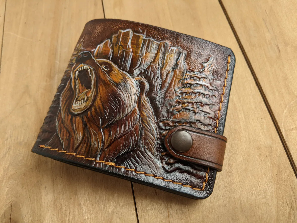 Leather bifold wallet featuring a detailed grizzly bear embossing