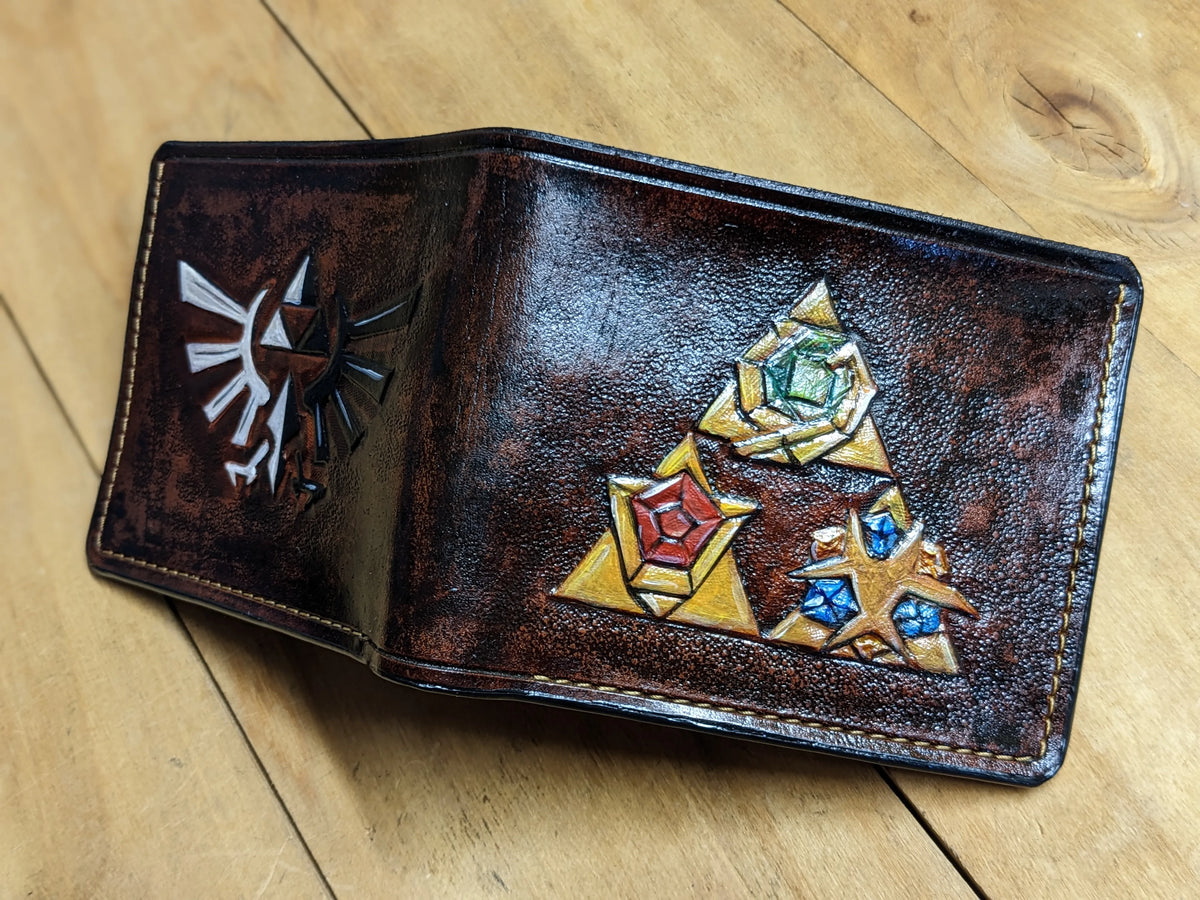 Full-grain leather Zelda LOZ wallet with hand-tooled Hylian Crest, crafted by Theodoros Leather with free worldwide shipping.
