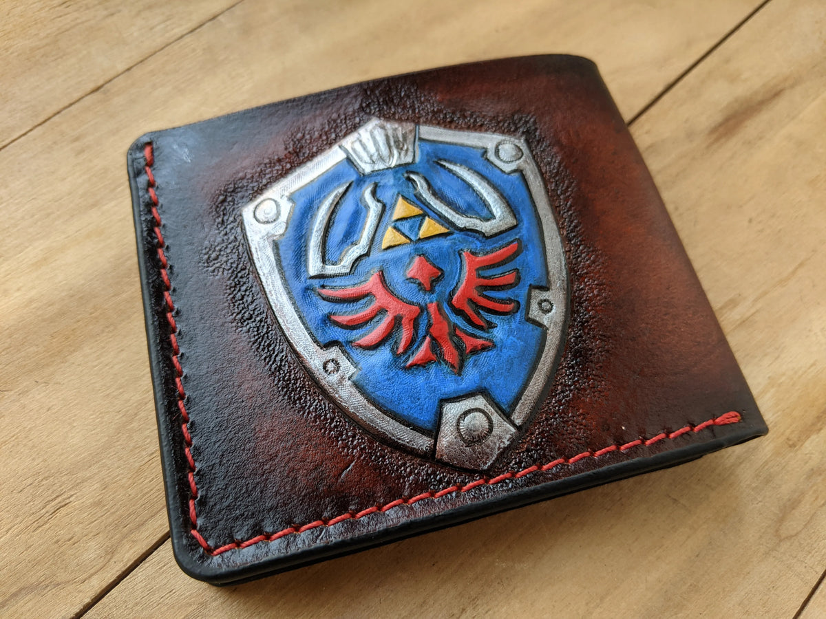 High-quality hand-tooled full-grain leather Zelda Hylian Shield wallet for men, designed by Theodoros Leather.