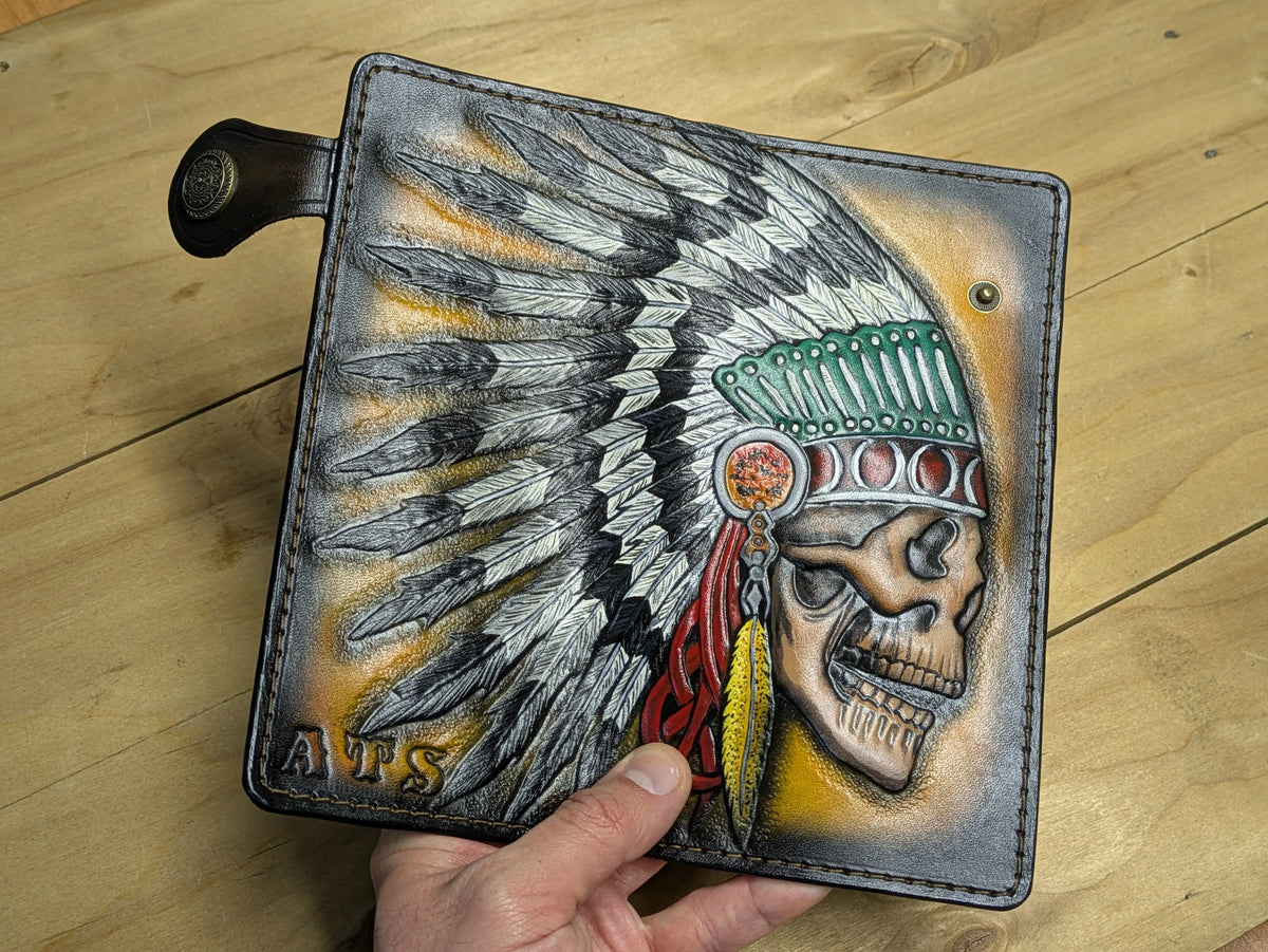 Custom handmade leather wallet exterior showcasing an expansive hand-carved feather headdress design.