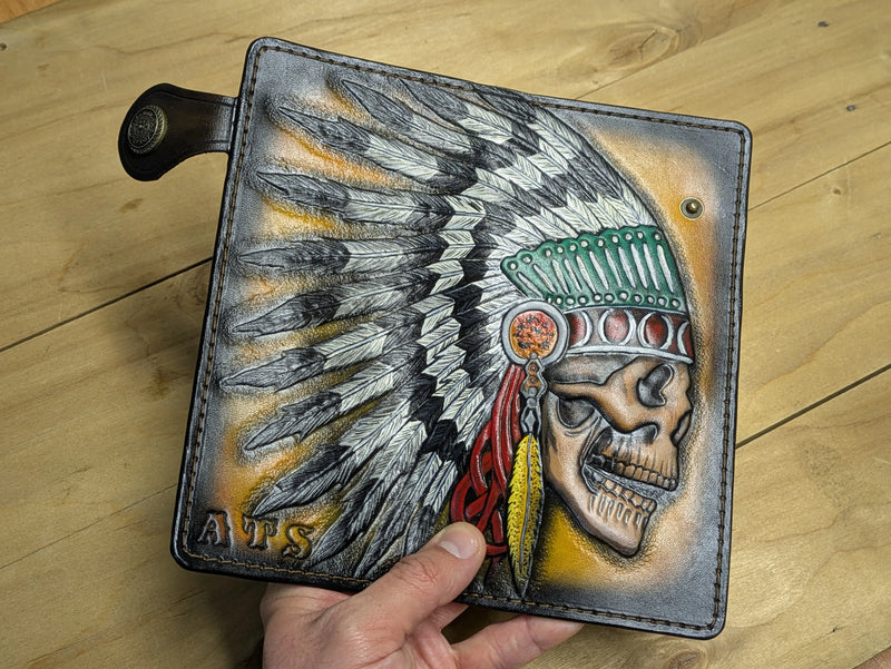 Custom handmade leather wallet exterior showcasing an expansive hand-carved feather headdress design.