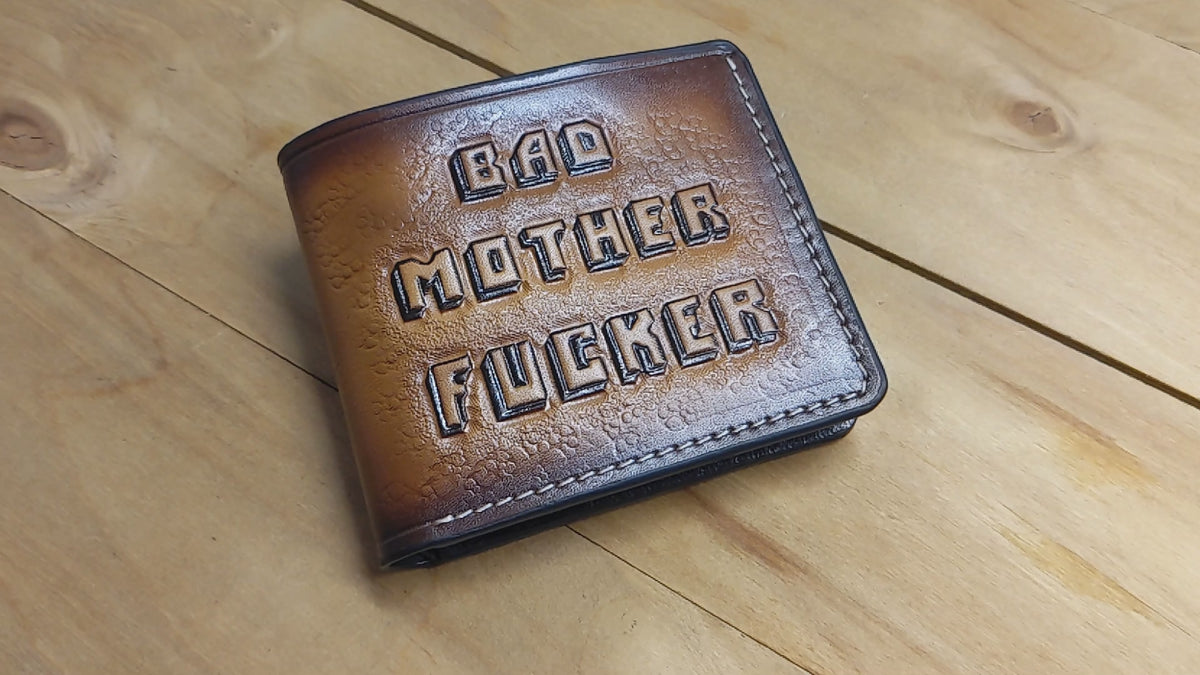 Artistic detail of “Bad Mother F*cker” painted leather wallet design