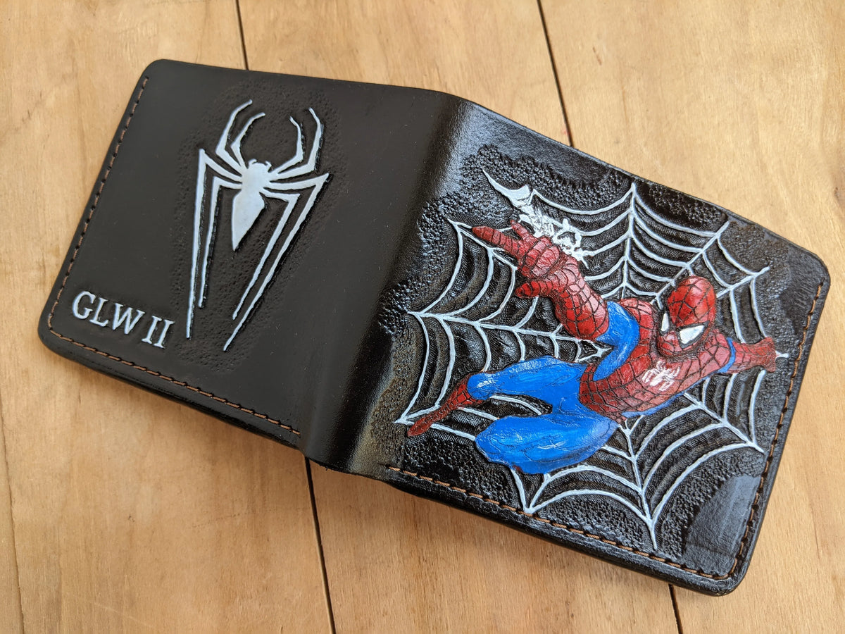 Fully opened custom Theodoros Spider-Man leather wallet showing the painted superhero carving on one side and spider logo on the back.