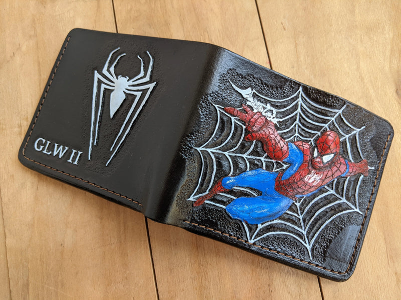 Fully opened custom Theodoros Spider-Man leather wallet showing the painted superhero carving on one side and spider logo on the back.