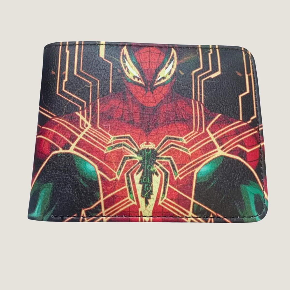 Black bifold full-grain leather wallet with a high-tech hand-tooled Marvel Spider Man suit graphic on a studio background.