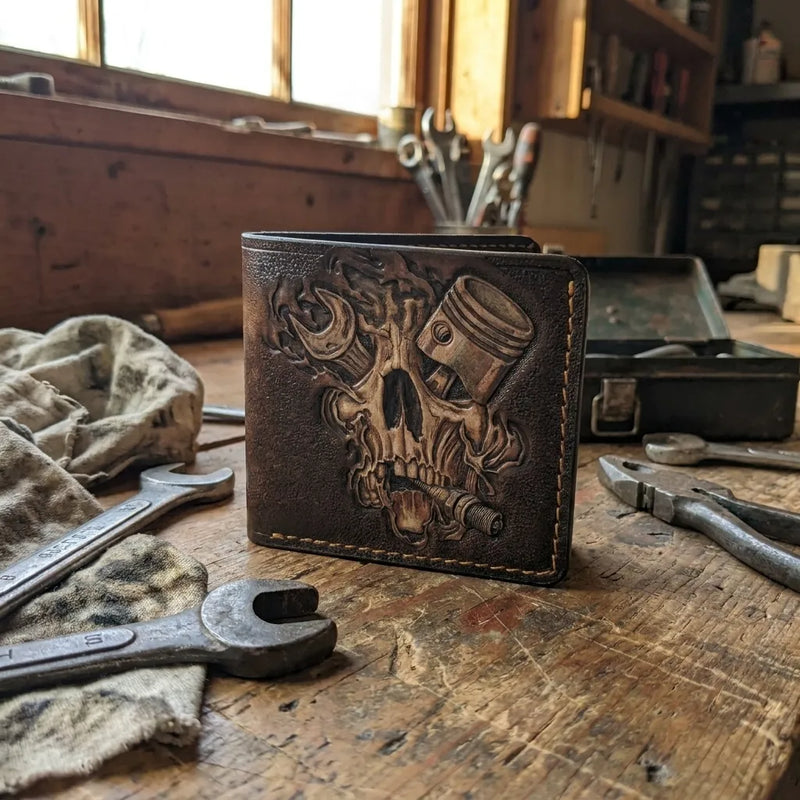 Custom biker leather wallet on a rugged mechanic workshop bench. Unique handmade Father's Day gift for car enthusiasts.