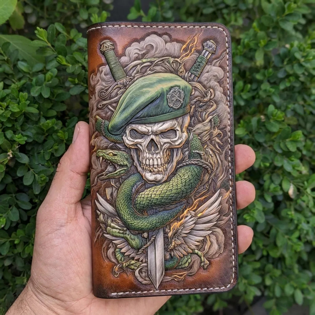 Close-up of a person holding a long, hand-carved leather truck wallet featuring a Green Beret skull and snake design.